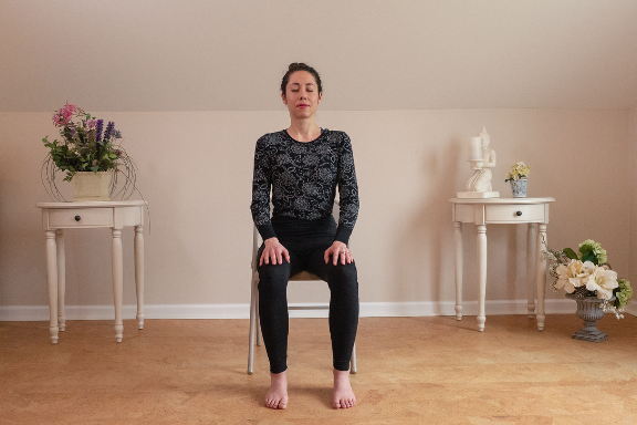 Woman practicing yoga meditation in chair