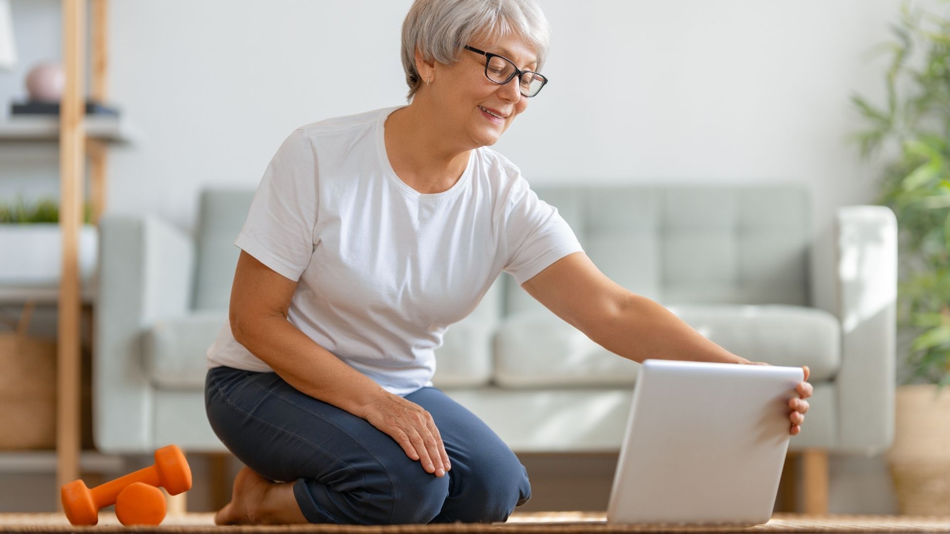 1. Woman yoga student sitting at her desk and comparing  300 hour Online Yoga Teacher Training Program