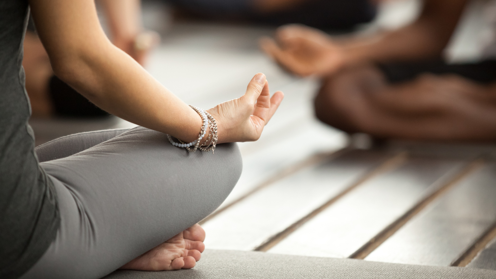 Young woman practicing yoga lesson sitting in Sukhasana Pose, Easy Sitting Pose with Mudra gesture.