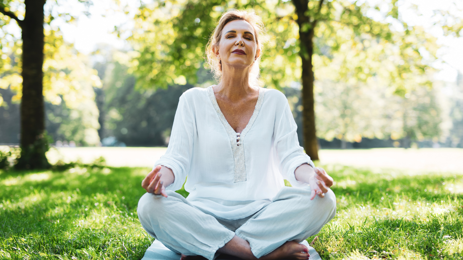 Woman sitting in Easy Pose and meditating.