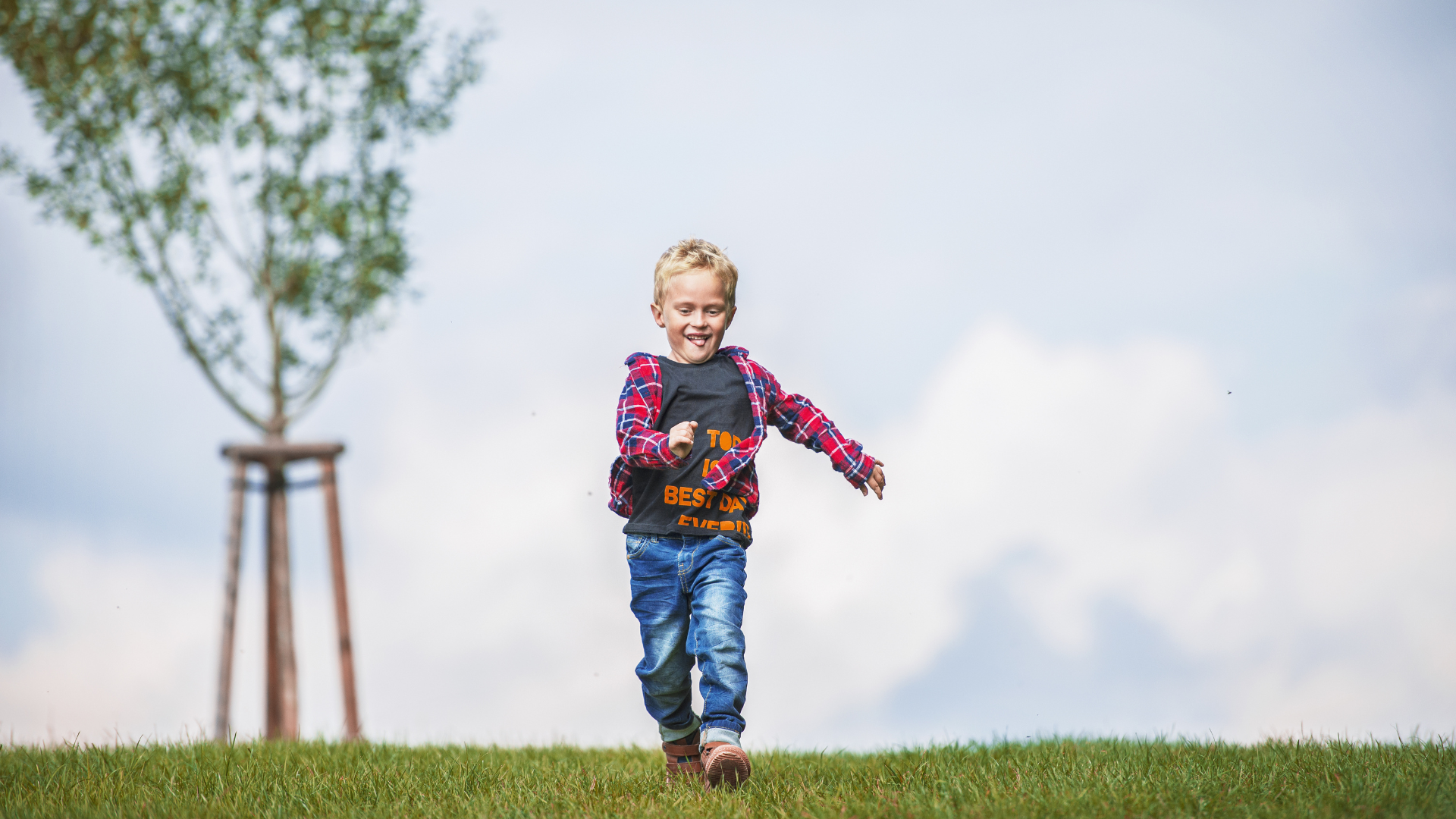 Young Boy running out in nature. Healthy concept.