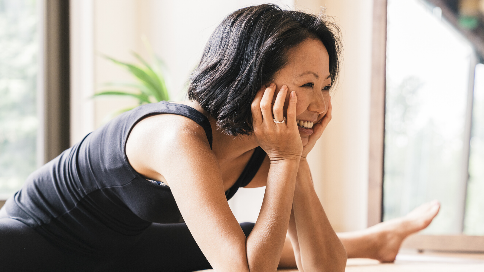 Serene woman relaxing on her yoga mat.