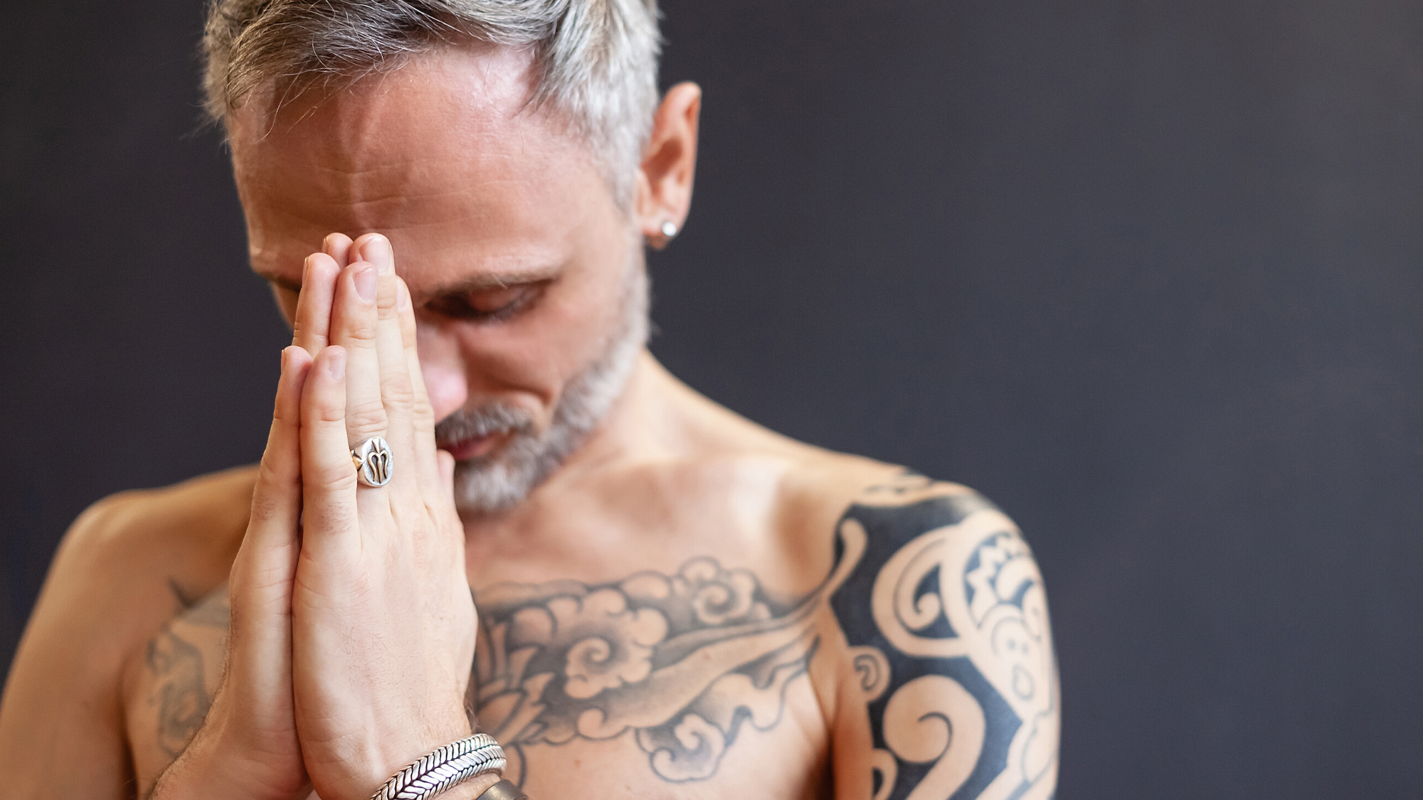 Man practicing yoga with hands in prayer gratitude meditation. 