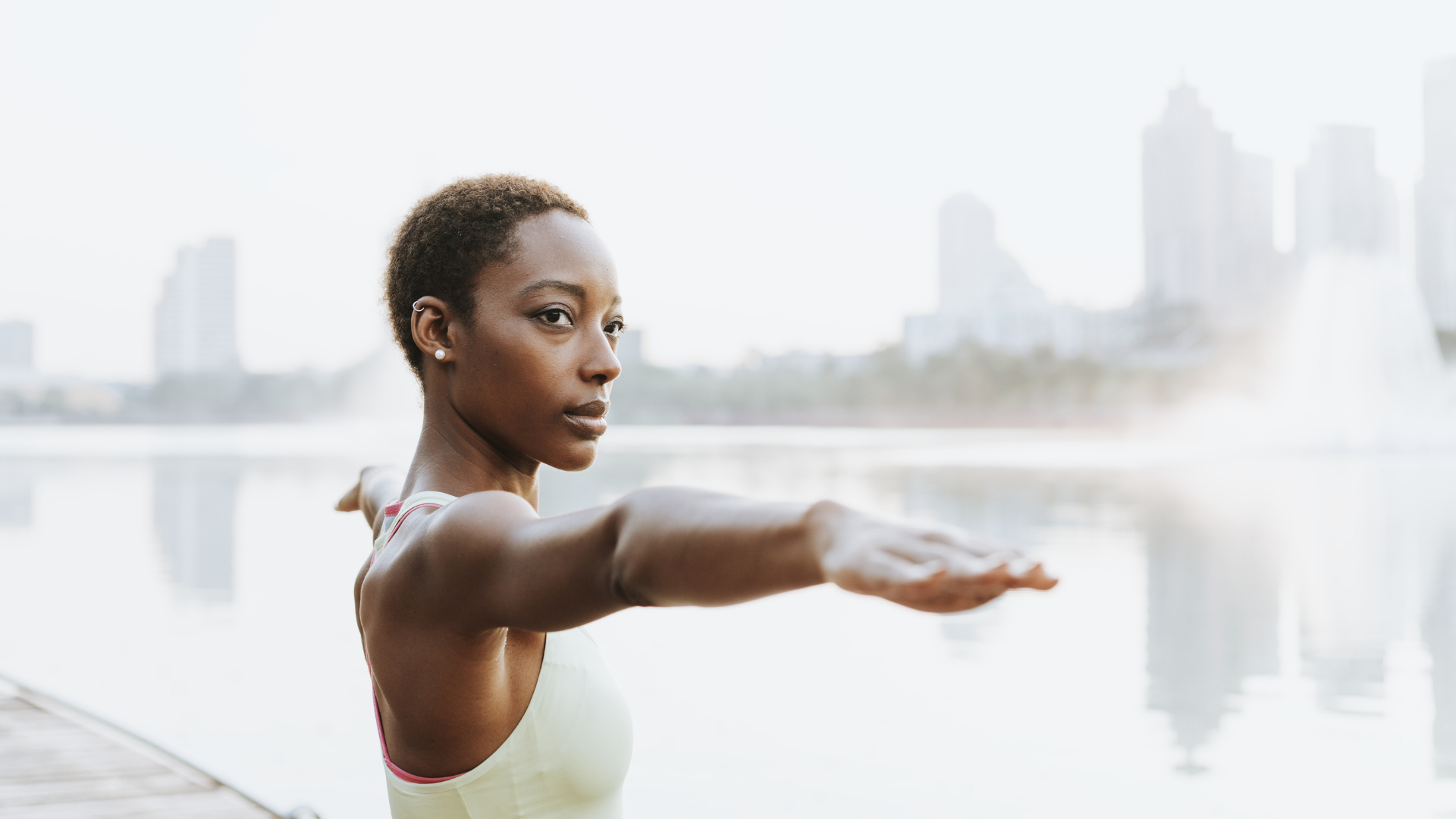 Yoga student practicing yoga principle of drishti or attention in Warrior II pose (Virabhadrasana II)