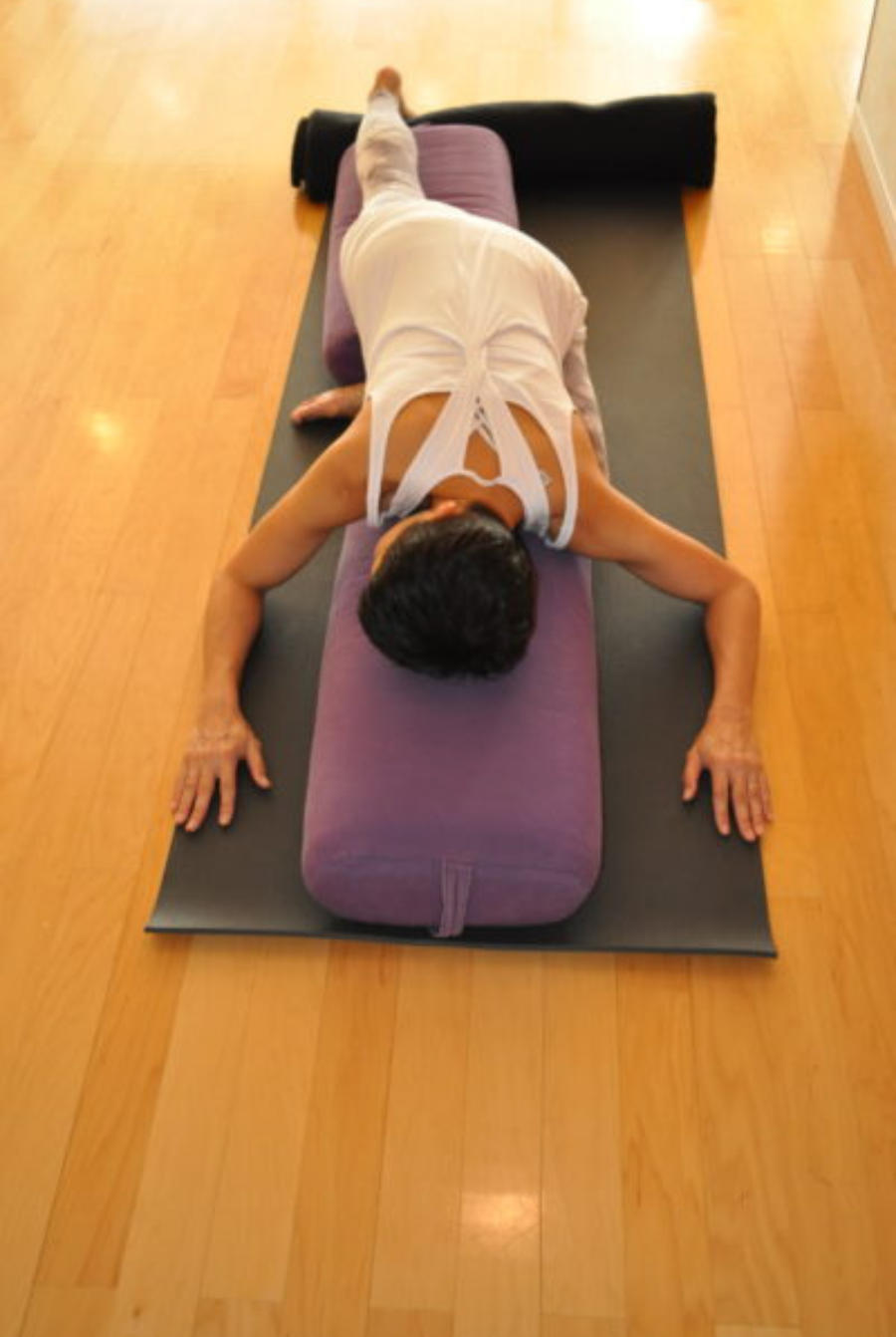 Image depicts arm and hip placement in Supported Pigeon Pose.