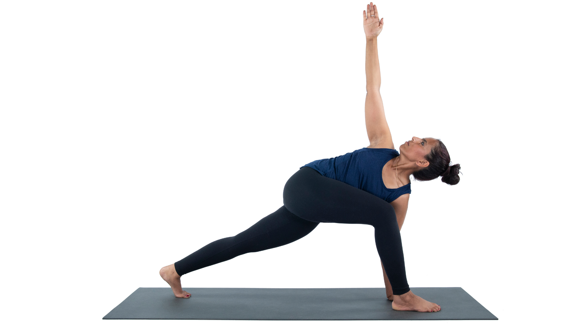 Female yoga student practicing Revolved Crescent Lunge yoga pose.