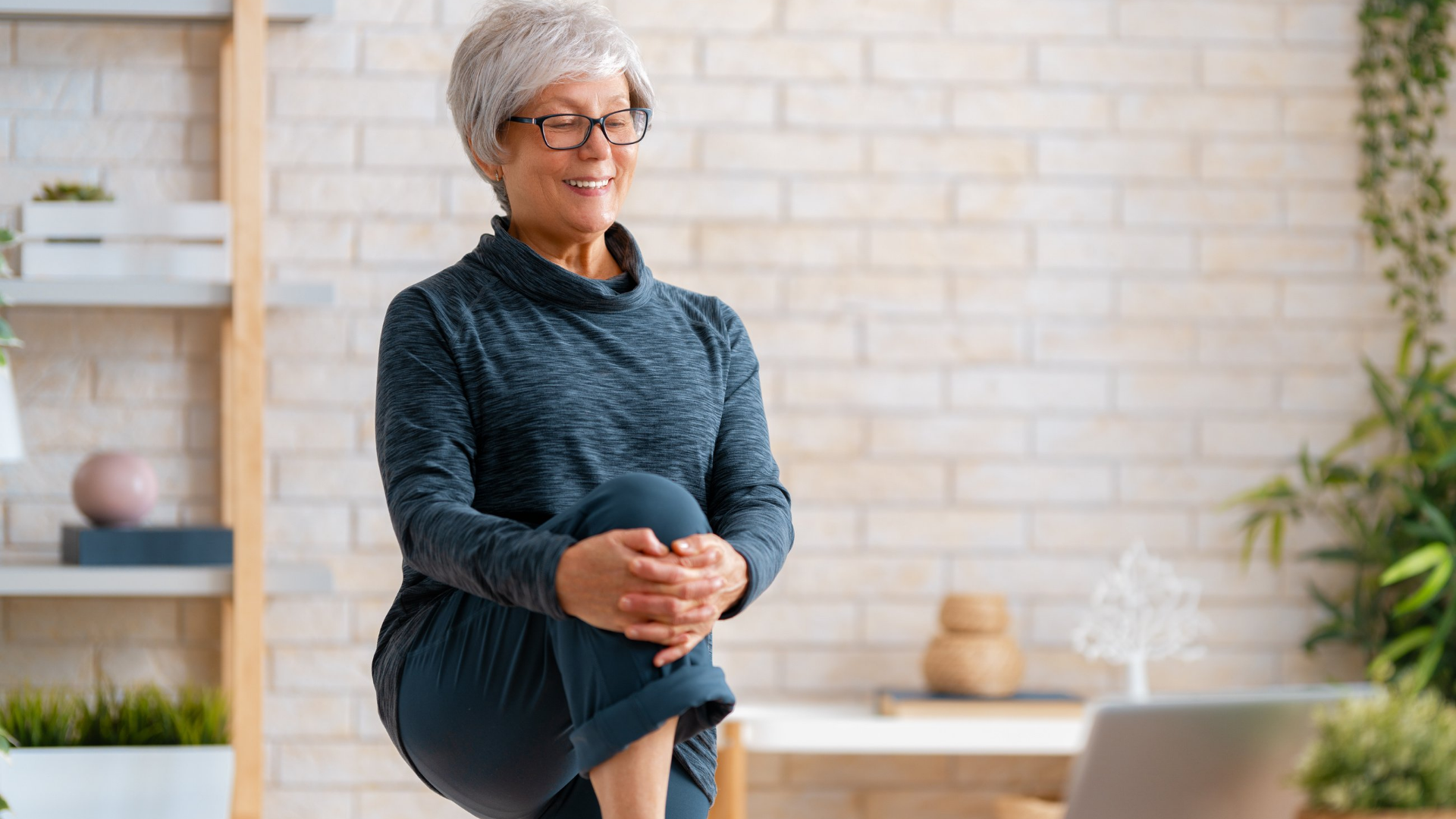 Woman yoga student practicing a balance Pose as part of her online Yoga Teacher Training