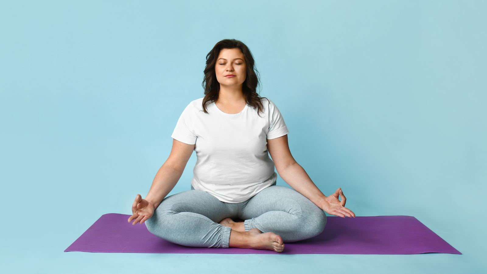 Beautiful woman meditating on color background.