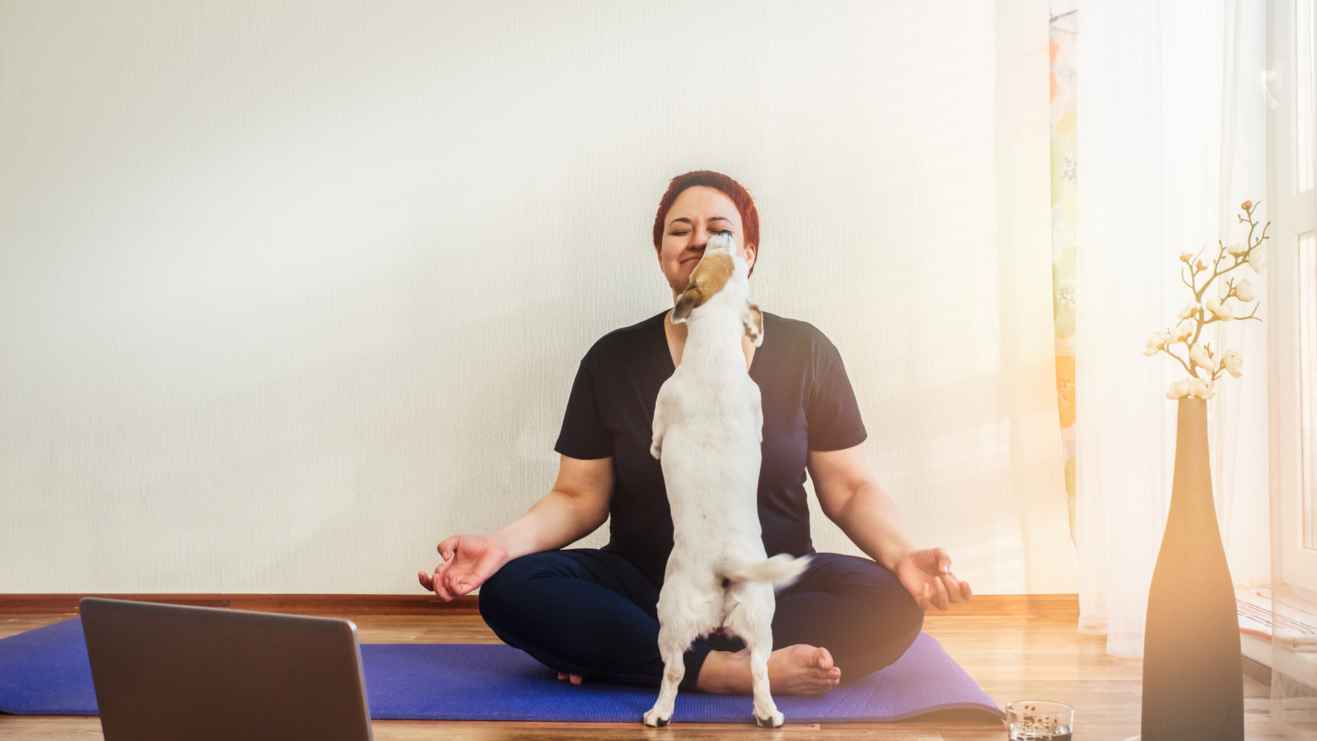 yoga_student_practicing_meditation_with_her_dog_at_home