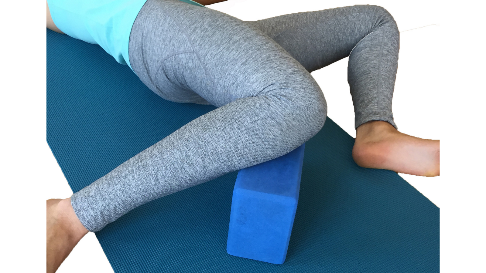 practicing yoga's traction twist with a block for extra support