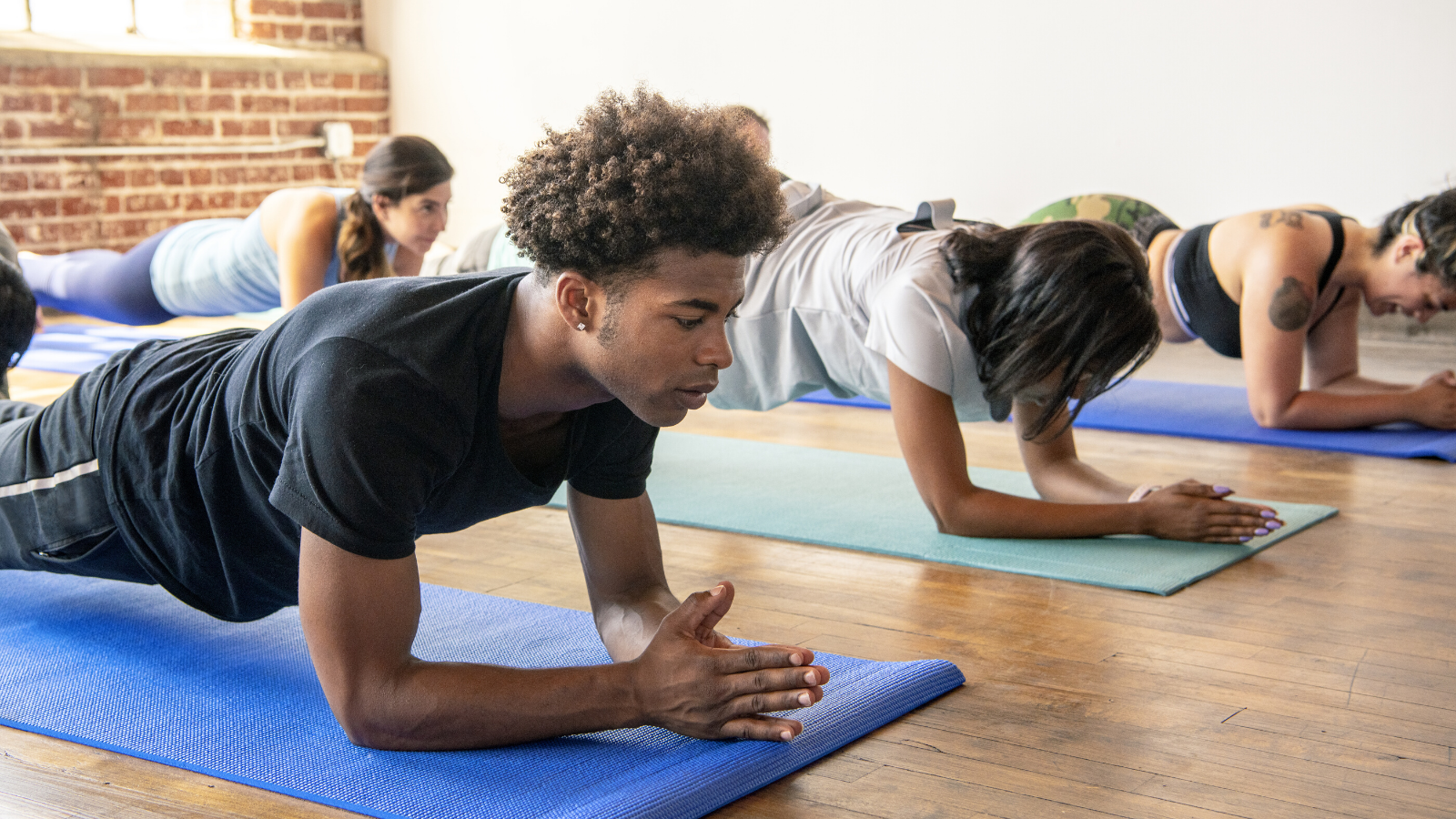 yoga-students-practicing-forearm-plank