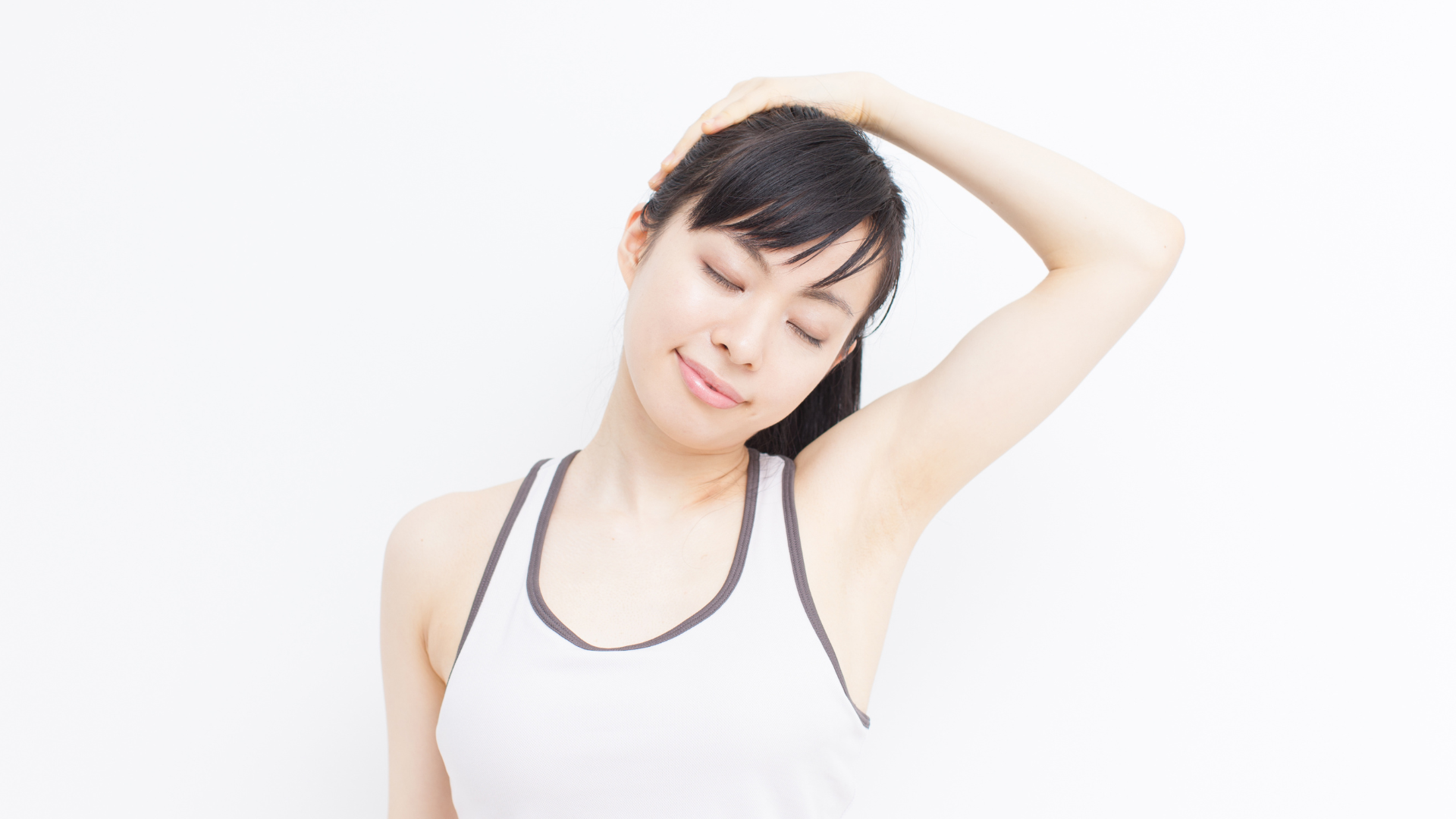  Young Yoga Student practicing a neck care warm up yoga exercise.