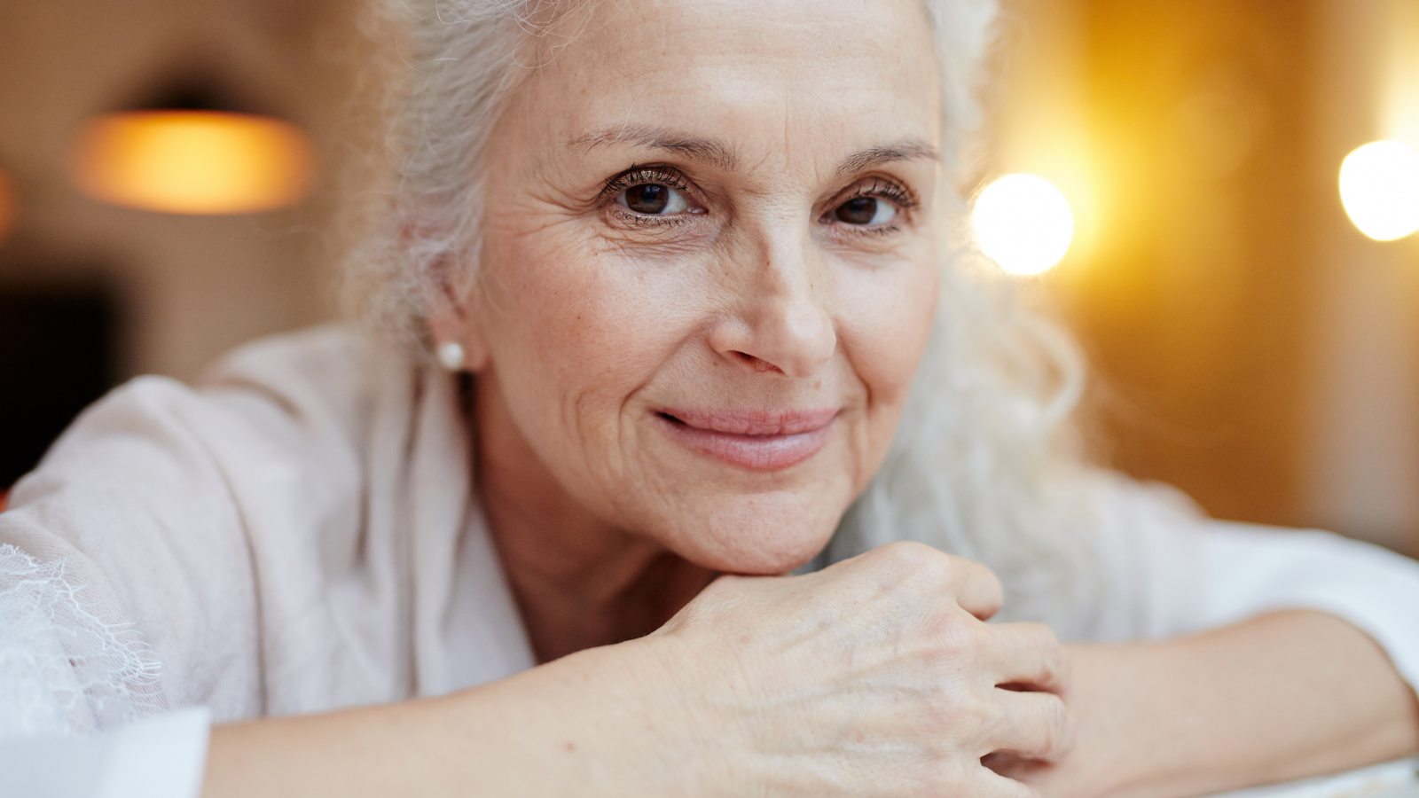 Happy grey-haired female yogini smiling at camera