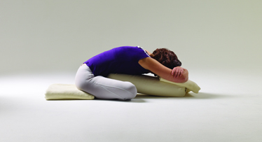 Adho Mukha Svastikasana, Downward Facing Svastikasana, yoga with props, yoga to relief fatigue