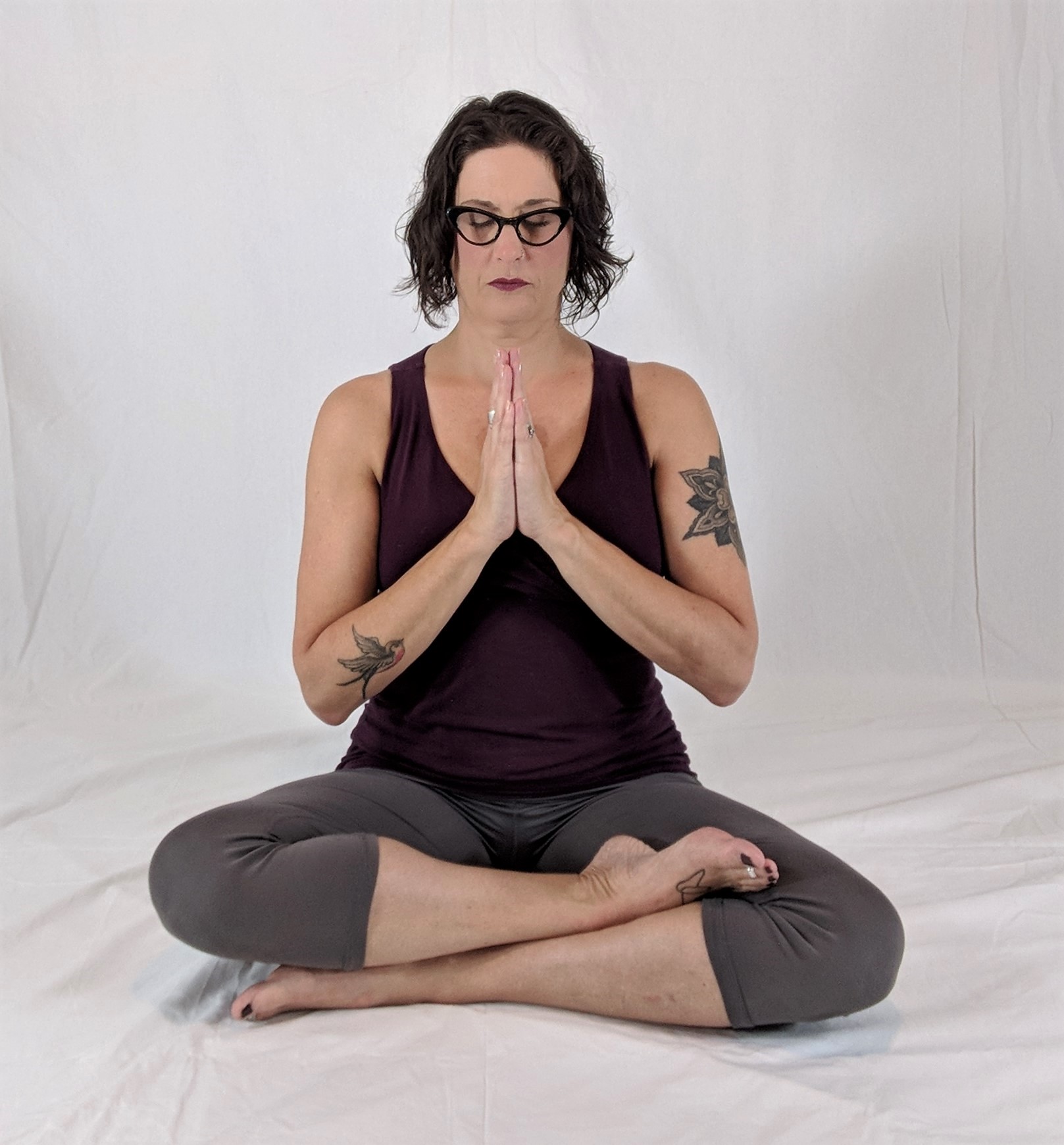 Yoga woman in Seated Pose with hands in anjali mudra (prayer gesture)