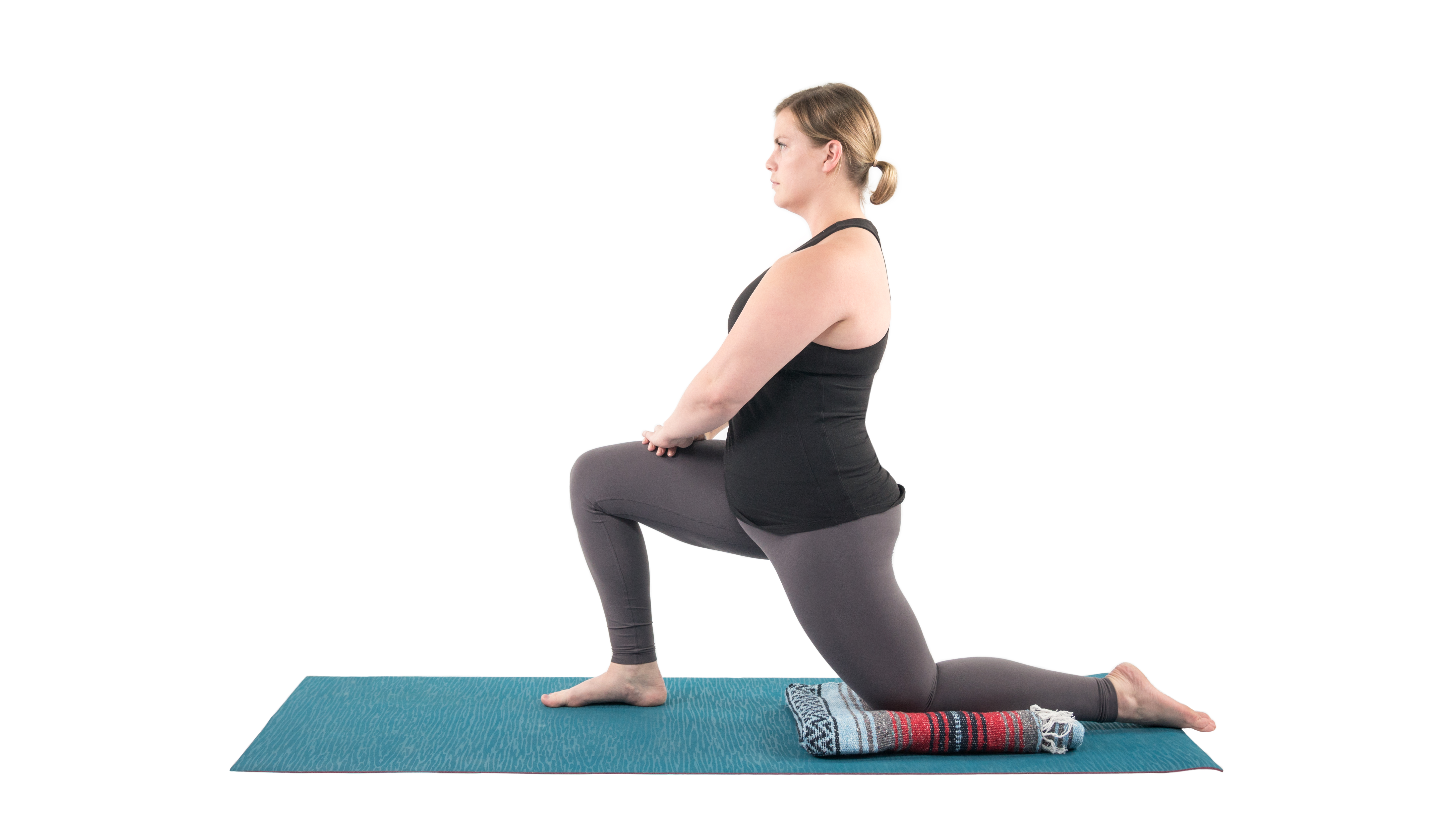 Woman in the low lunge quad stretch yoga pose in preparation for the Dancer Pose (Natarajasana)  