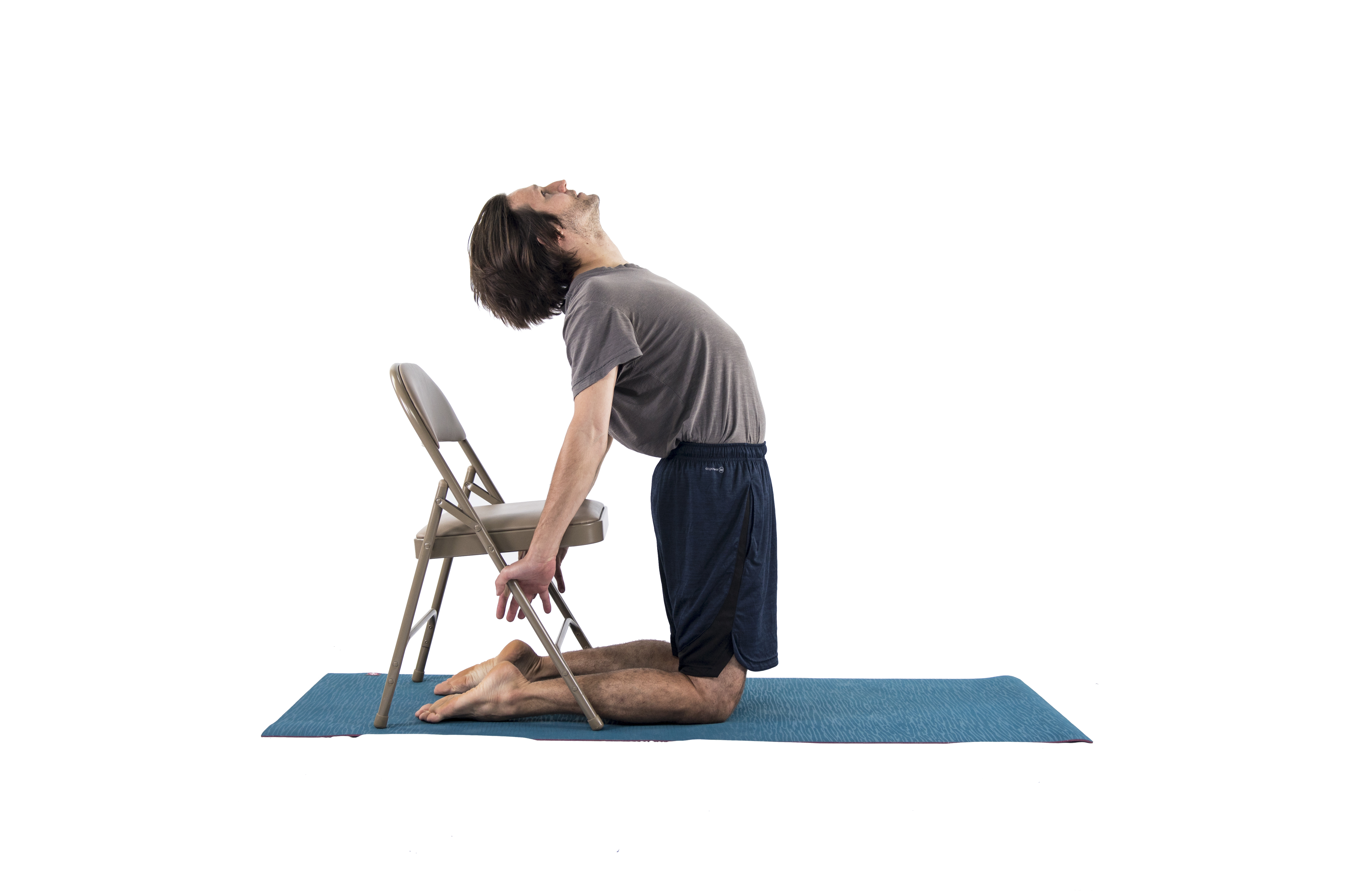 Man in Camel yoga Pose (Ustrasana) to open the chest and practice backbending in preparation for Dancer Pose