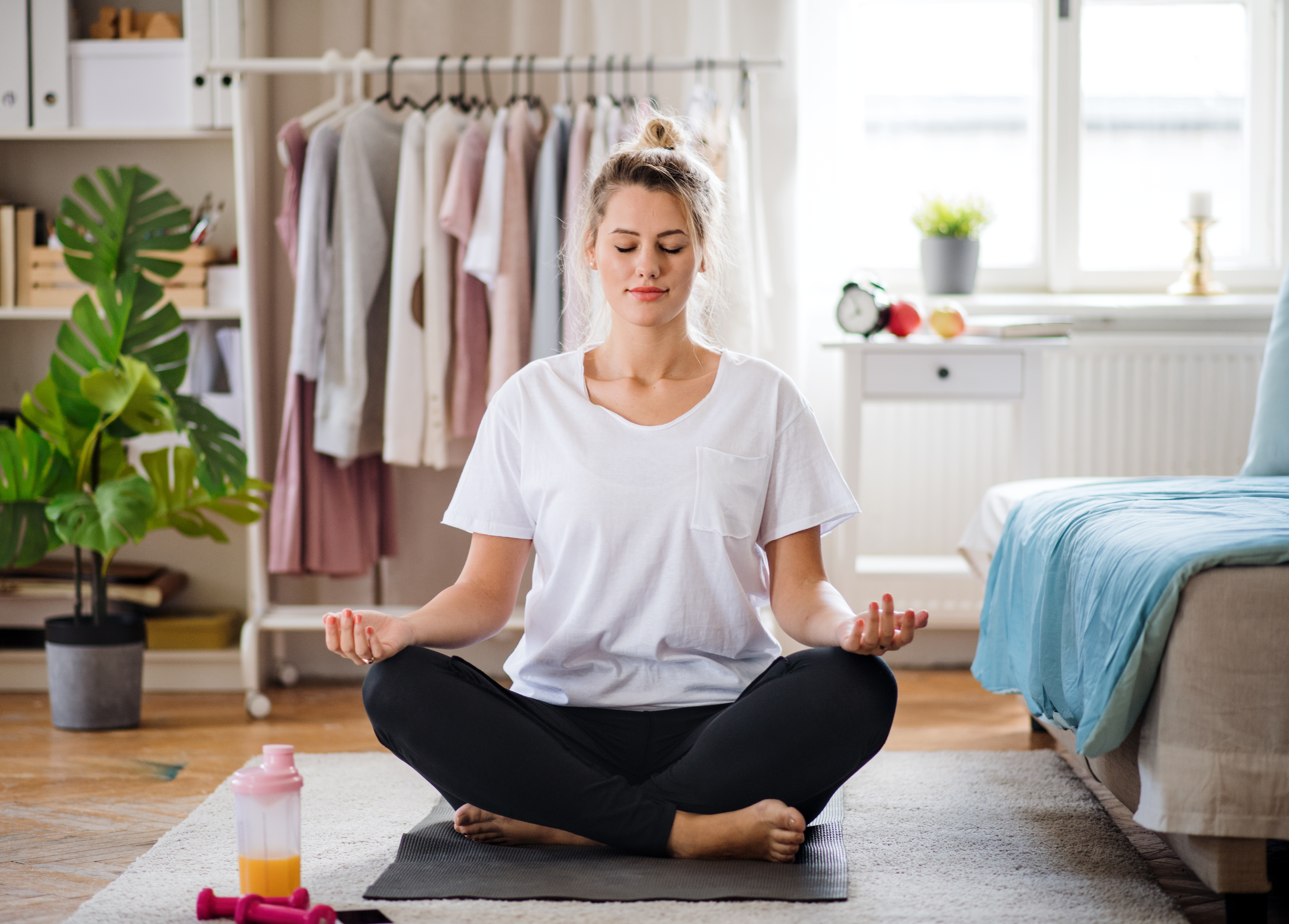 yoga student on her mat contemplating practicing yoga with a new baby and a new body