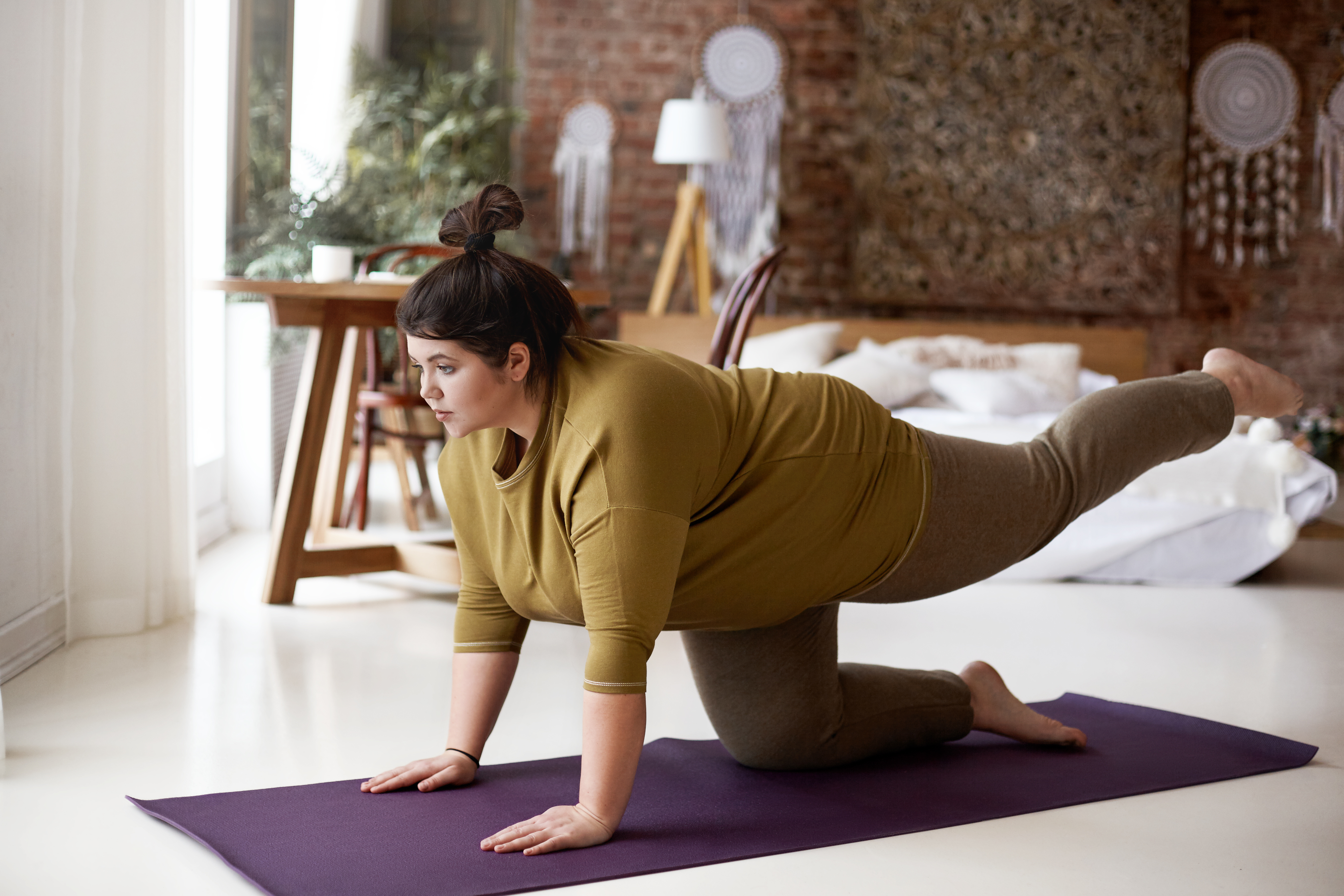 Larger woman practicing yoga, weight issues and yoga, diverse yoga classes