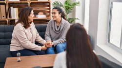 Three woman mother and daughter having psychology therapy at psychology center