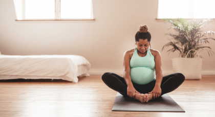 Practicing prenatal yoga designed for pregnant people in Bound Angle Pose (Baddha Konasana)