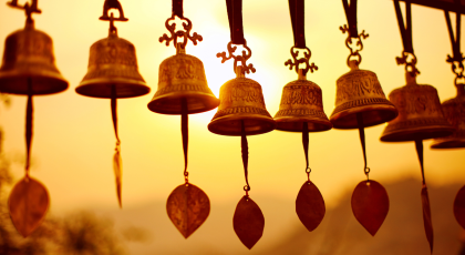 Nepali traditional Bells over the sun at sunset