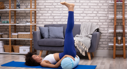 Woman practicing Legs up the Wall yoga pose (Viparita Karani)