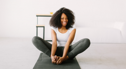 Young woman practicing yoga Bound Angle Pose (Baddha Konasana)