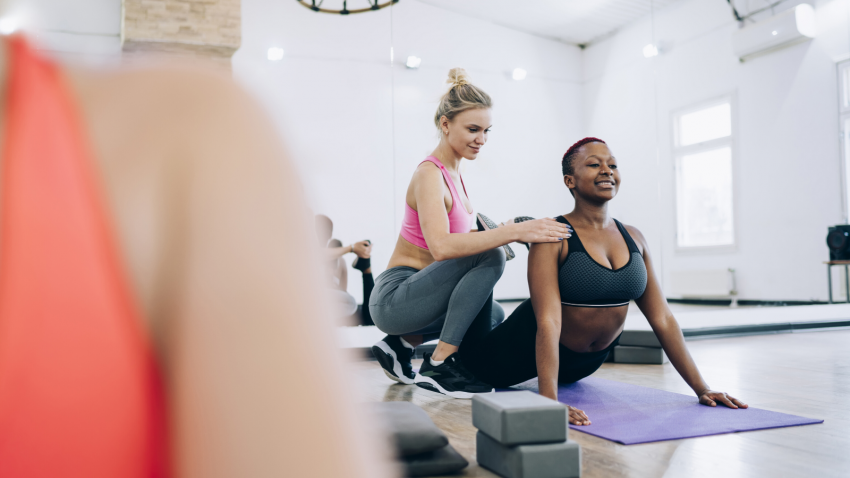 yoga-teacher-hands-on-adjustment