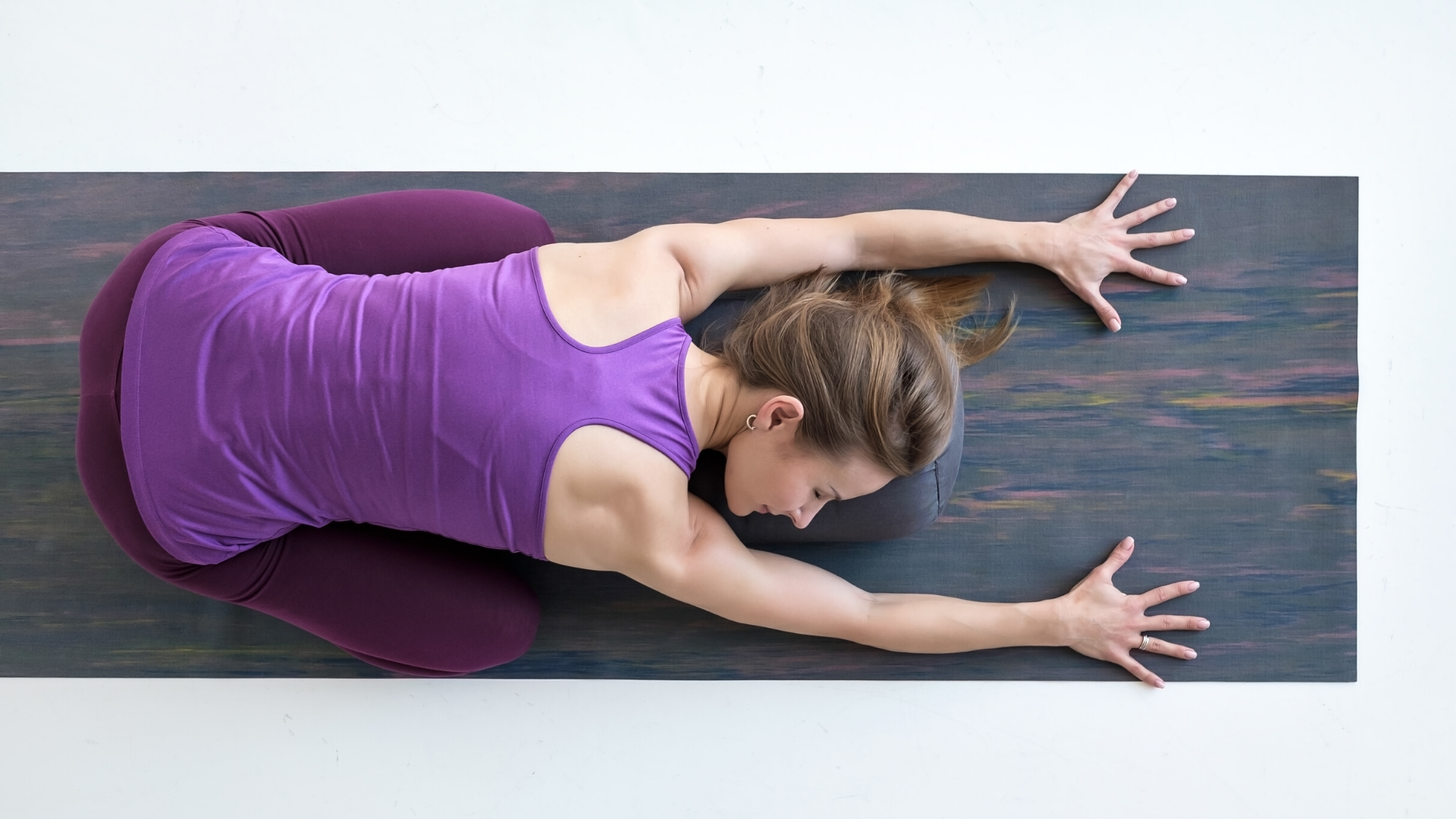 Female yoga student practicing balasana child's pose